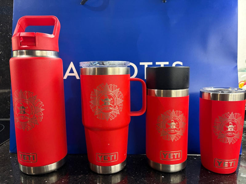 Dublin Fire Brigade crest on a line-up of red YETI drinkware