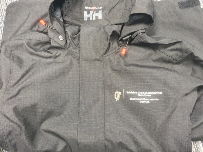 National Monuments Service logo on a black Helly Hansen jacket