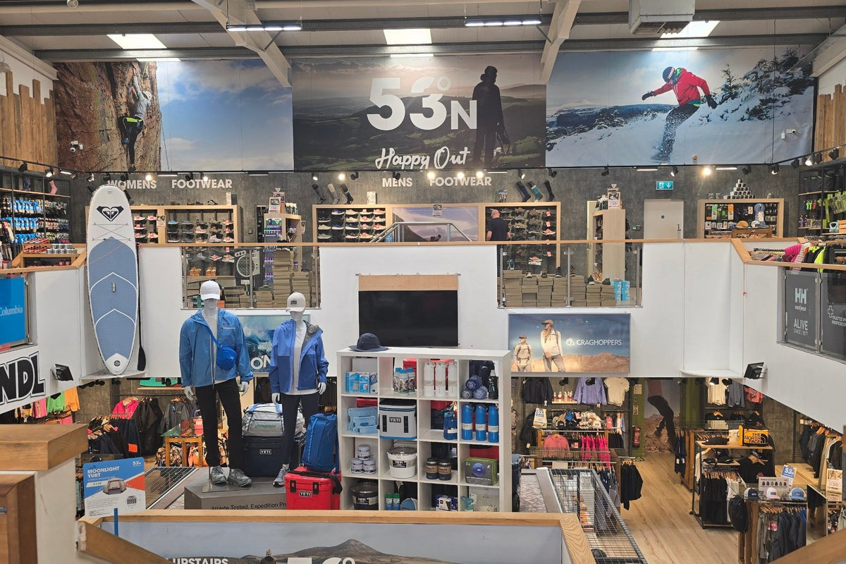 Looking across both floors of 53 Degrees North Carrickmines, with walking boots and shoes upstairs and clothing below