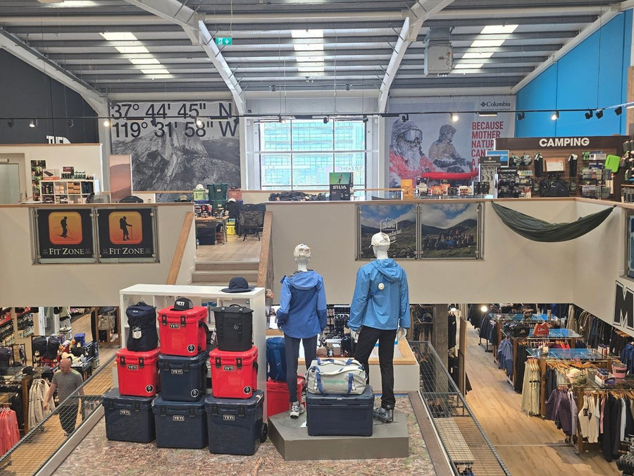 Looking across the upper floor of 53 Degrees North Carrickmines, with camping gear upstairs and clothing below
